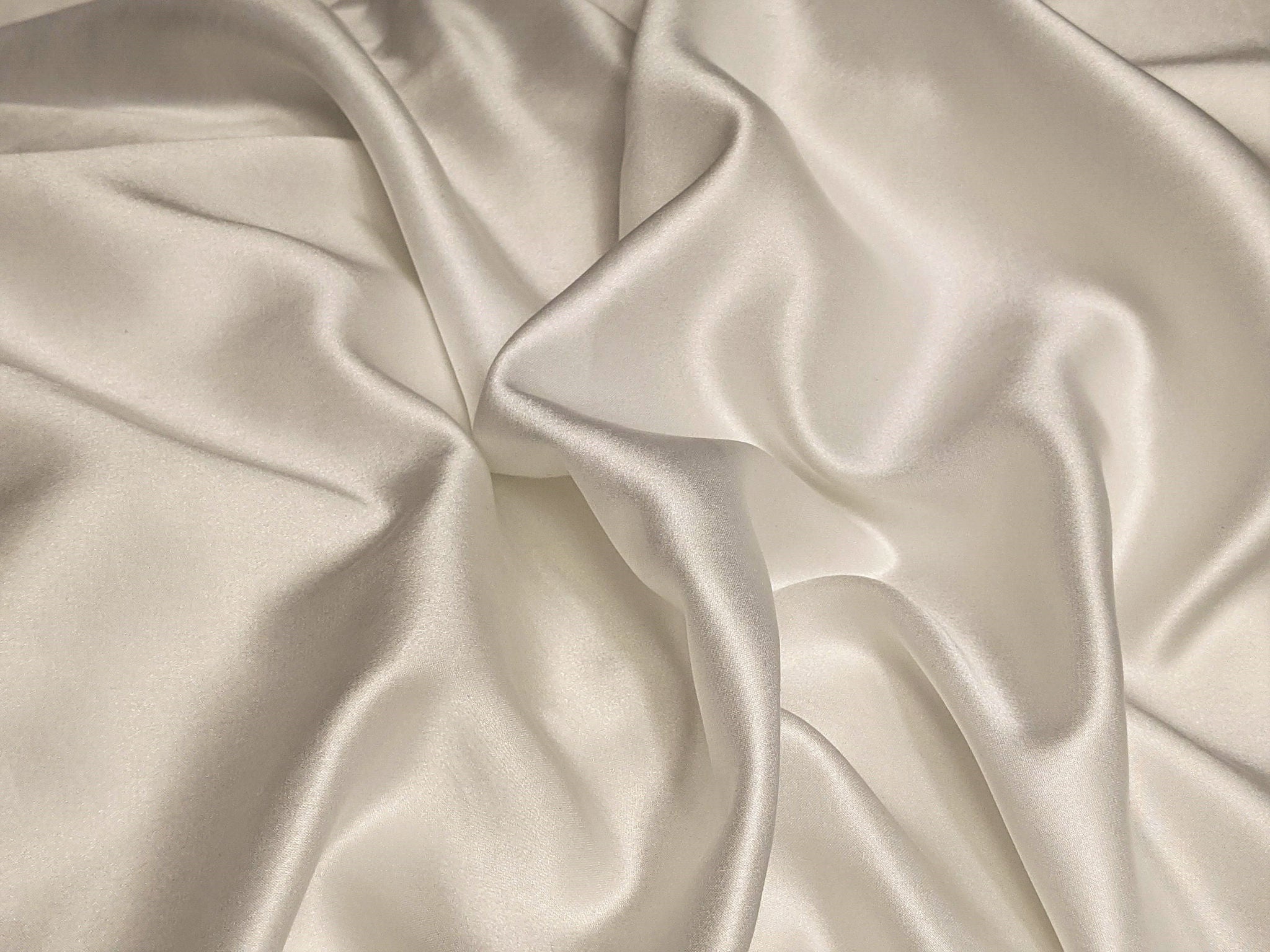 Close-up of white satin fabric folds