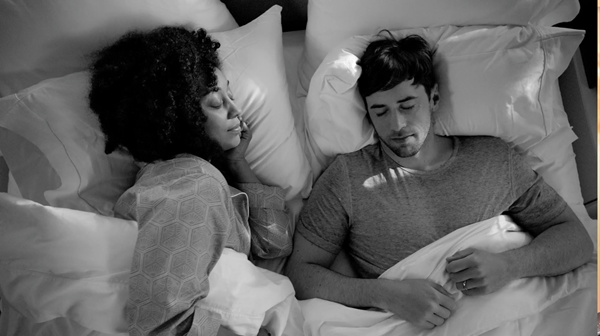 Couple resting in a cozy bed