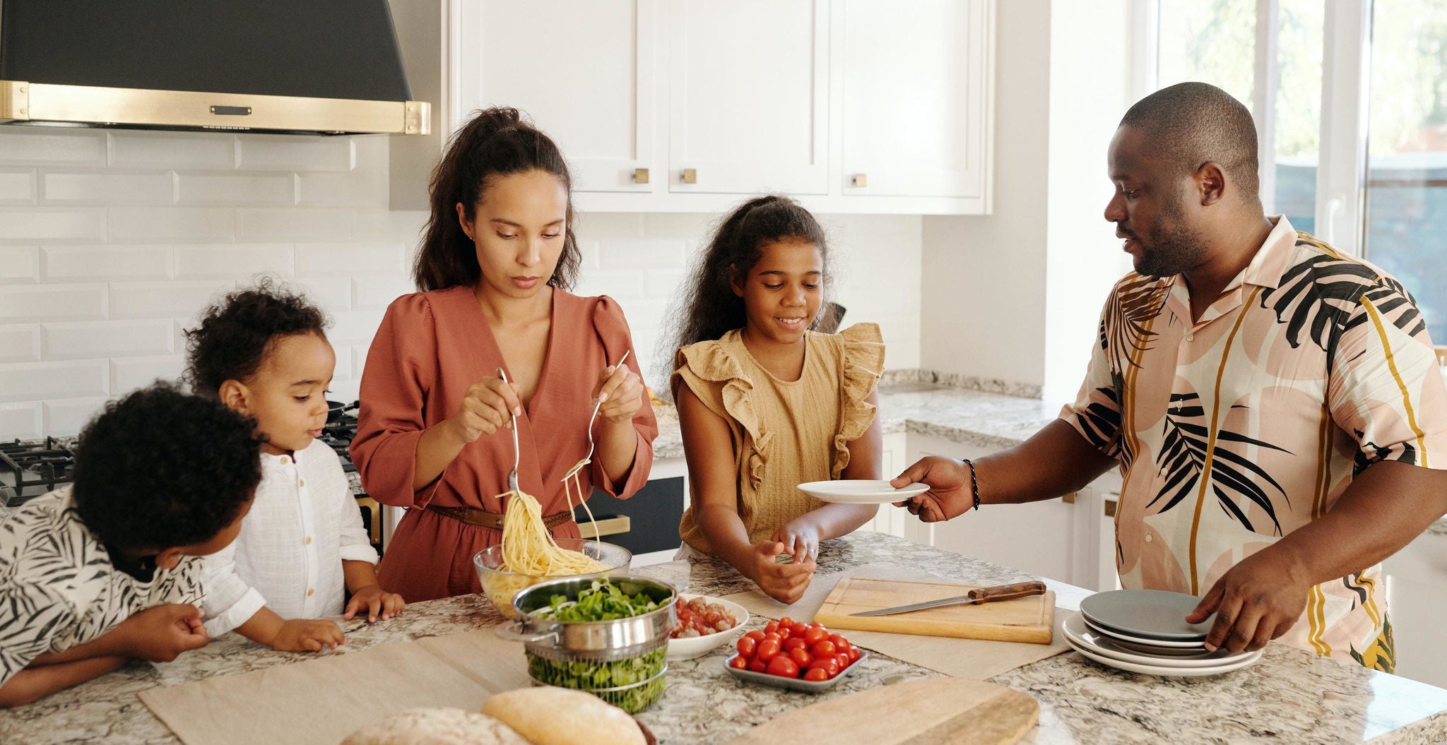 Family cooking together in modern kitchen