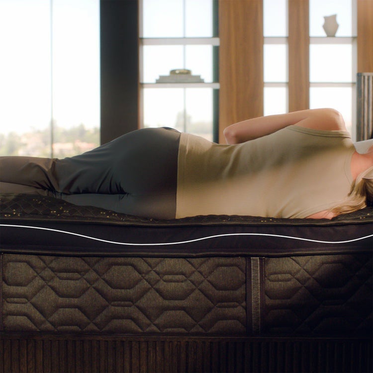 Woman resting on modern mattress