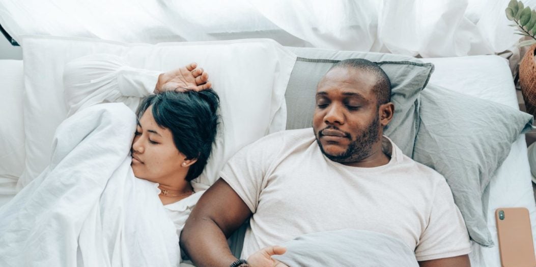 Couple relaxing in cozy bedroom setting