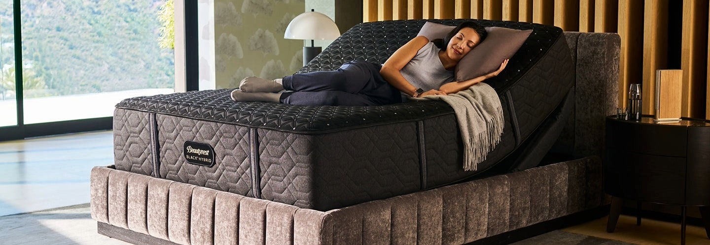 Woman relaxing on adjustable mattress in modern room